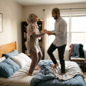 Two people dancing on a bed with a blurred effect